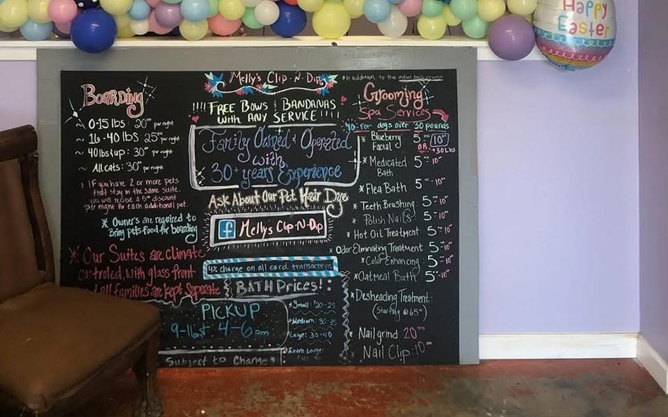 The shop's chalkboard price list under Easter balloons
