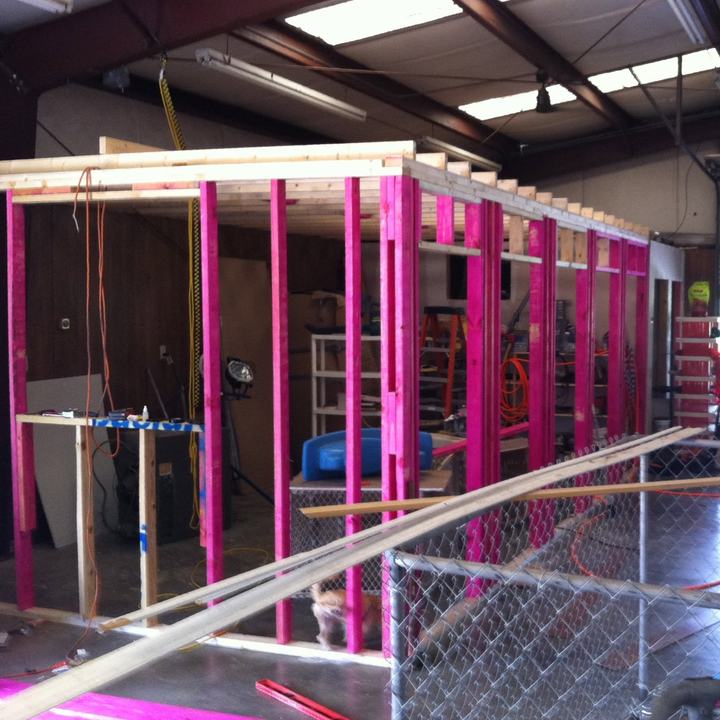 The boarding suites being framed in pink lumber in 2011, with chain-link runs behind